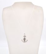 A stamped sterling silver necklace in the shape of anchor and ships wheel with a rope chain and