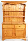 A 20th Century pine dresser, the base having twin drawers above twin cupboards with knob handles
