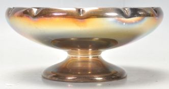A mid Century silver hallmarked footed bowl having a shaped rim raised on a round footed base.