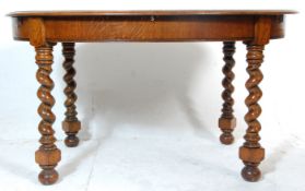 A good 1930's early 20th Century barleytwist oak dining table. The table having an oval top raised