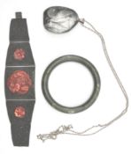 A Chinese cinnabar and white metal strap bracelet inset with inset cinnabar roundels. The verso