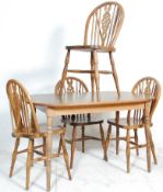 A set of four 20th Century wheel back dining chairs having rail backs with pierced wheel splats