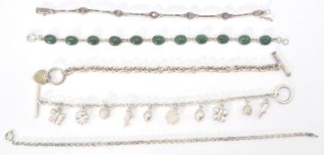A collection of silver bracelets to include a charm bracelet, malachite cabochon set, pink stone