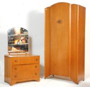 A 1930's Art Deco oak veneer bedroom suite. The suite comprising a wardrobe having domed door and