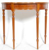 A 20th Century antique style mahogany demi lune side table having a serpentine front with single