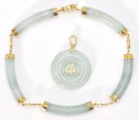 A 14ct yellow gold and jade Chinese  bracelet and necklace pendant suite. The doughnut shaped
