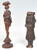 Two antique carved treen ware black forest decorative tools to include a corkscrew in the form of