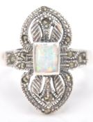 A stamped sterling silver art deco style dress ring decorated with marcasite and a central opal