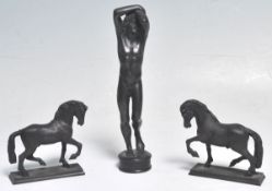 A group of three cast bronze 19th Century Grand Tour figurines to include two horses each raised