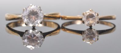 Two hallmarked 9ct gold and white stone solitaire rings, both set with round cut white stones in