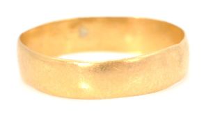 A hallmarked 22ct gold band ring of plain form. Ha
