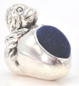 A stamped sterling silver pincushion in the form of a newly hatched chick with velvet cushion to the
