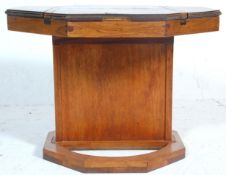 A 20th Century vintage unusual scratch built octagonal games table having a columnal support on a