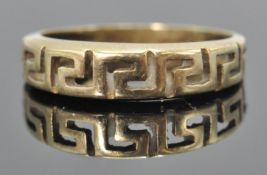 A stamped 585 14ct gold ring having pierced greek key decoration. Weight 1.8g. Size K.