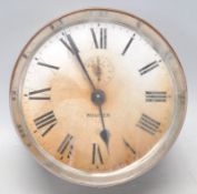 A retro vintage travel alarm clock by Rouser cased in brass. The circular face has a white chapter