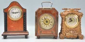 A collection of antique mantel clocks to include a faux birds eye maple German mantel clock with a