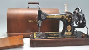 A vintage early 20th Century oak cased Singer Sewing machine having a good dome carry case with