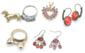 A continental gilded silver dog brooch. In the form of a dachshund with  stone set collar, pin