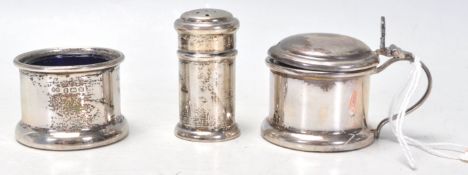 A set of three silver hallmarked table cruets to include a pepperette, table salt and lidded jam