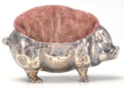 An early 20th Century English silver hallmarked pin cushion in the form of a pot belly pig having