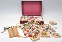 A collection of vintage costume jewellery to include mid Century gilt brooches and earrings