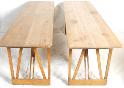 A pair of vintage retro 20th Century industrial wooden trestle tables having planked table tops with
