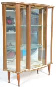 A retro mid 20th Century 1950's formica breakfront china display cabinet vitrine. Raised on tapering