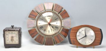 A group of three vintage retro clocks to include an Art Deco Ferranti bakelite cased electric clock,
