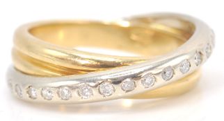 An 18 ct mixed gold diamond set crossover ring. Weighs 9.2g. Size 7.0 .04 points.