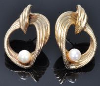 A pair of hallmarked 9ct gold vintage ladies stud earrings having knot design drops set with pearls.