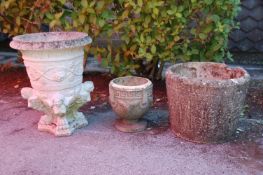 A group of three early 20th Century reconstituted stone garden planters to include a round planter