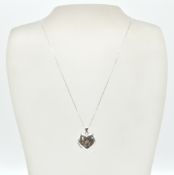 A 9ct white gold heart pendant locket and back chain. The fine linked necklace chain with c-clasp.