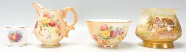 A group of four Royal Worcester vases to include a with sheep in front of a thatched cottage Nr