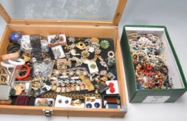 A collection of vintage costume jewellery all set within a wooden glazed top display case to include