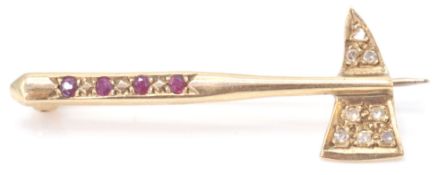 A 9ct gold bar brooch in the form of an axe inset with diamonds and garnets, pin verso. Total weight