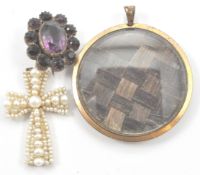 An antique pearl crucifix together with a mourning locket with platted hair encased in yellow