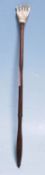 A 19th Century Victorian back scratcher having a carved bone hand scratcher on a turned dark wood