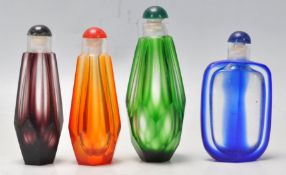 A set of 4 vintage faceted glass perfume bottles in various colours. Measures 9 cm long.