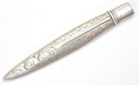 An antique Edwardian  hallmarked sterling silver needle case in the form of a feather with etched