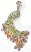 A 20th century art nouveau style sterling silver and plique a jour brooch in the form of a peacock