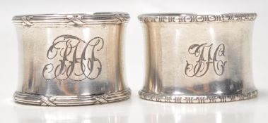 Two silver hallmarked napkin rings to include one with gadrooned borders and engraved initials to