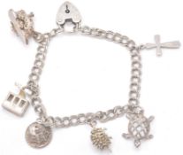 A contemporary hallmarked sterling silver charm bracelet with charms in the shape of a heart