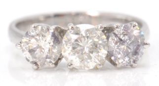 An 18ct white gold ring with 3 impressive princess cut diamonds within a four prong setting.