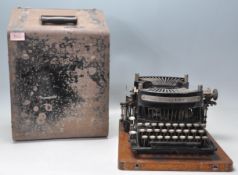 An early 20th Century Williams Academy Model typewriter having a black painted metal body with round