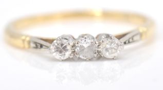 An 18ct gold, diamond and platinum ring. The ring with 3  round cut diamonds in prong setting to
