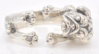 A stamped sterling silver expandable ring in the shape of a pug dog. Stamped .925 Weighs 6.5g.