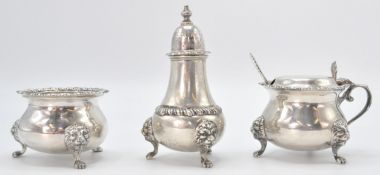 A group of three Harrods retailed silver hallmarked table cruets each being raised on lion mask feet