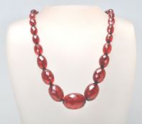 A Victorian Bakelite / early plastic faceted cherry necklace of graduating form. Beads measure