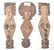 A group of three African tribal carved fertility figures / wall plaques having elongated faces