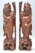A good pair of Antique Chinese root carvings of wise men. Each figure having glass set eyes with